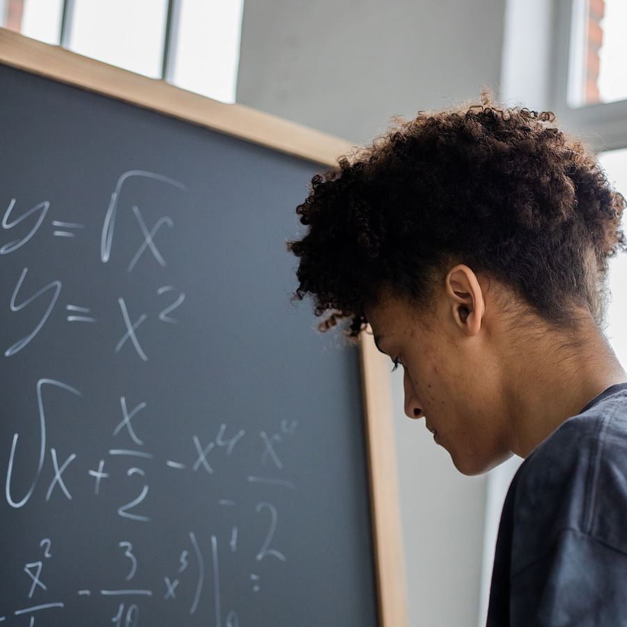 Worried student calculating student loan costs